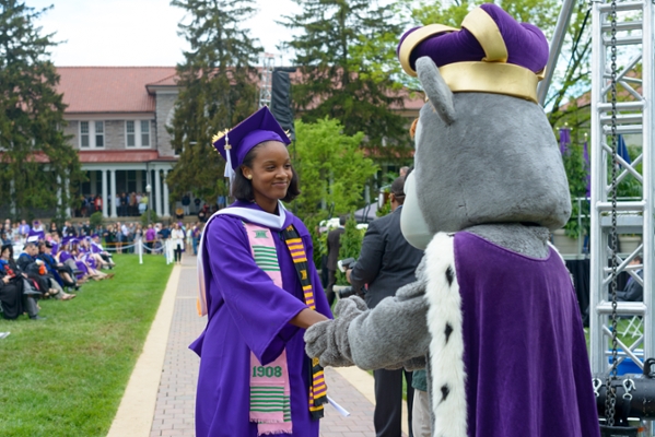 Duke Dog congratulating a new grad.